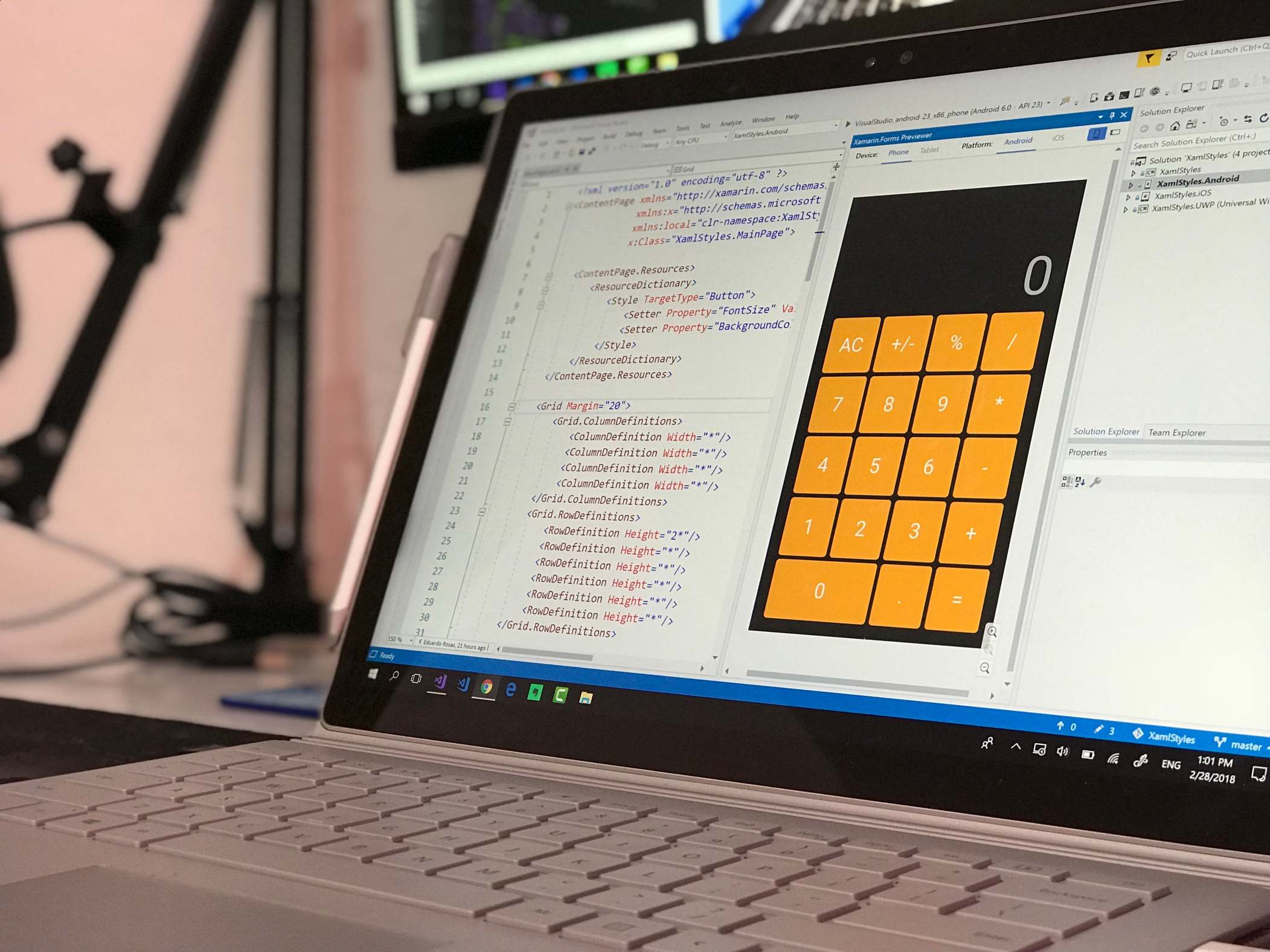 Close view of a laptop showing source code on the screen, laptop screen shows a coding application in a tech office setting